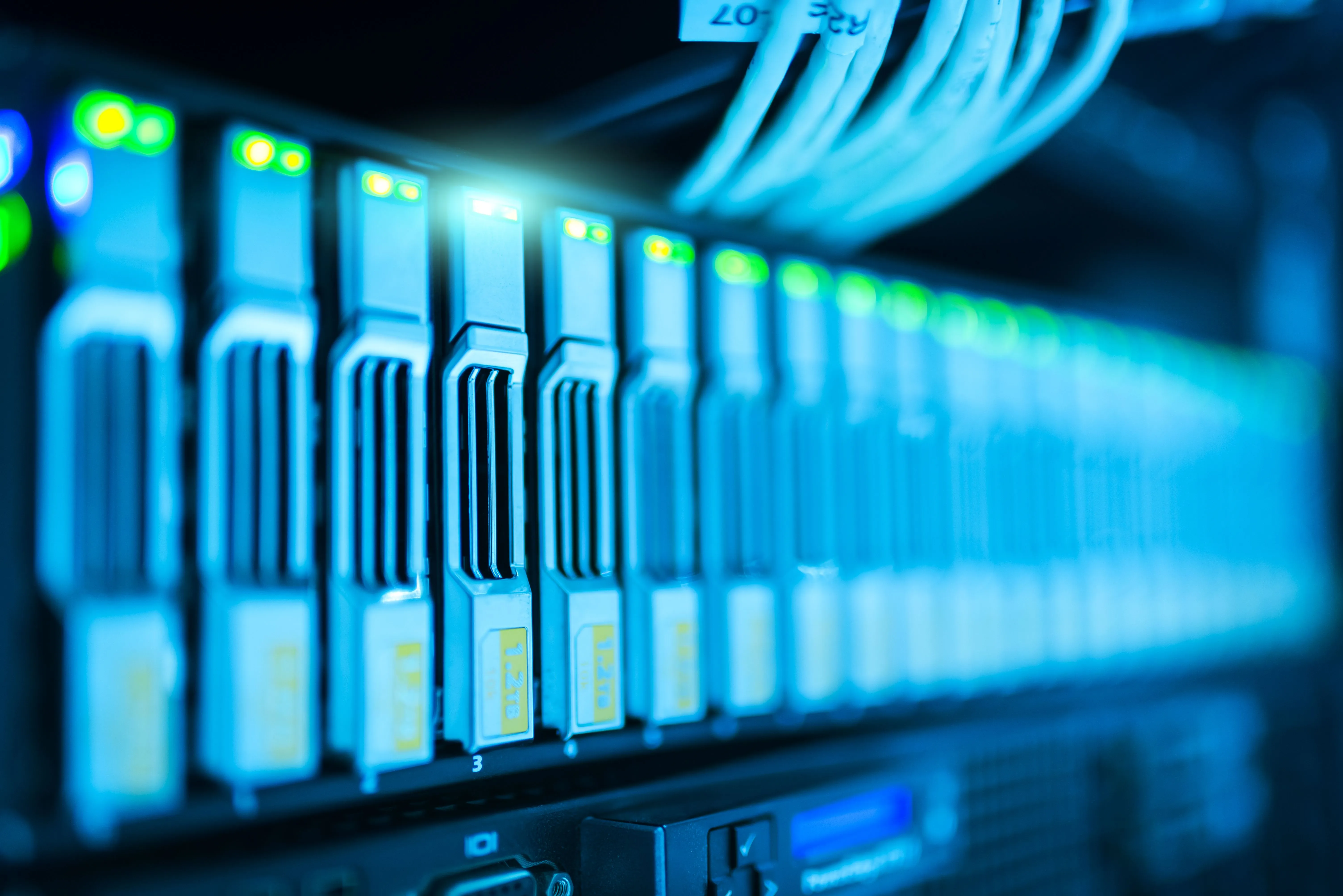 Close-up of blue-lit server racks and network cabling in a data center